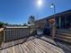 Sunny backyard deck with wooden steps, shed and plantings at 8437 Indies Dr, Hudson, FL 34667