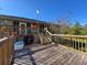 Backyard deck with wooden stairs, plantings and view of the home's rear at 8437 Indies Dr, Hudson, FL 34667
