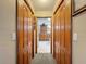 Hallway with a view through to a kitchen at the end and two doors on either side at 8437 Indies Dr, Hudson, FL 34667