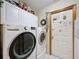 Laundry room with white cabinets and modern LG washer and dryer at 8437 Indies Dr, Hudson, FL 34667