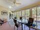 Bright sunroom features tile floors and a dining area overlooking the outdoors at 8437 Indies Dr, Hudson, FL 34667