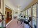 Bright sunroom featuring tile floors and a dining area overlooking the outdoors at 8437 Indies Dr, Hudson, FL 34667