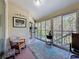 Relaxing sunroom with tile flooring, rocking chairs, and outdoor views at 8437 Indies Dr, Hudson, FL 34667