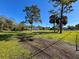 View of large grassy yard with mature trees and home at 8437 Indies Dr, Hudson, FL 34667