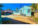 An exterior view of the backyard with a shed and the back of the home with blue trim at 860 16Th S Ave, St Petersburg, FL 33701