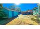 An exterior view of the backyard with a shed and the back of the home with light blue trim at 860 16Th S Ave, St Petersburg, FL 33701