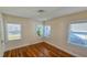 Bedroom with hardwood floors and natural light streaming through three windows at 860 16Th S Ave, St Petersburg, FL 33701