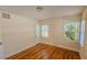 Bright bedroom with hardwood floors, white walls, and windows providing natural light at 860 16Th S Ave, St Petersburg, FL 33701