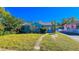 Charming blue home featuring a well-maintained lawn and inviting curb appeal on a sunny day at 860 16Th S Ave, St Petersburg, FL 33701