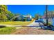 Charming single-story home with a brick driveway and well-maintained front yard under a clear blue sky at 860 16Th S Ave, St Petersburg, FL 33701
