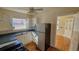 Compact kitchen featuring white cabinetry, a ceiling fan, and laminate countertops at 860 16Th S Ave, St Petersburg, FL 33701