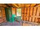 Shed interior view with exposed framing, small window, and an old sink with paint chipping off at 860 16Th S Ave, St Petersburg, FL 33701