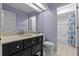 Bathroom featuring a vanity with drawers, a toilet and a shower tub with blue curtains at 8746 Tantallon Cir, Tampa, FL 33647
