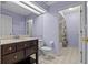 Bathroom featuring a vanity with a dark wood finish and a shower at 8746 Tantallon Cir, Tampa, FL 33647