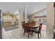 Dining room with views of the pool area and open to the kitchen and living room at 8746 Tantallon Cir, Tampa, FL 33647