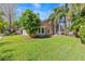 Charming single-story home with lush green lawn and mature trees on a sunny day at 8746 Tantallon Cir, Tampa, FL 33647