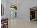 Spacious foyer with high ceilings, neutral flooring, chandelier, and views into other rooms at 8746 Tantallon Cir, Tampa, FL 33647