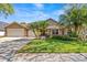 Beautiful home featuring well-manicured front yard with lush landscaping, palm trees, and a three car garage at 8746 Tantallon Cir, Tampa, FL 33647
