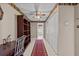 Hallway featuring tiled floors, closet doors, wallpaper and a ceiling fan at 8746 Tantallon Cir, Tampa, FL 33647