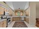 Traditional kitchen with light wood cabinets, white countertops, and stainless steel appliances at 8746 Tantallon Cir, Tampa, FL 33647