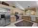 Charming kitchen with light wood cabinetry and stainless steel appliances at 8746 Tantallon Cir, Tampa, FL 33647