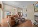 Open-concept living space with ample seating, fireplace and view of the dining area at 8746 Tantallon Cir, Tampa, FL 33647