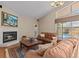 Cozy living room with a fireplace and sliding glass doors leading to the screened-in pool area at 8746 Tantallon Cir, Tampa, FL 33647