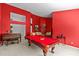 Spacious combined living and game room featuring a pool table, piano and red walls at 8746 Tantallon Cir, Tampa, FL 33647