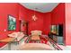 Living room with red walls, couches, carpet floors, a bookshelf and a chandelier at 8746 Tantallon Cir, Tampa, FL 33647