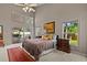 Bright and airy main bedroom offering abundant natural light, vaulted ceiling, and private patio access at 8746 Tantallon Cir, Tampa, FL 33647
