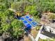 Overhead shot of blue pickleball courts nestled among trees, providing a fun recreational option for residents at 8746 Tantallon Cir, Tampa, FL 33647