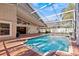 Screened-in pool area with brick patio, providing a perfect outdoor oasis for relaxation at 8746 Tantallon Cir, Tampa, FL 33647