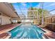 Inviting screened-in pool with brick patio, offering a private and refreshing retreat at 8746 Tantallon Cir, Tampa, FL 33647