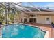 Sparkling in-ground pool surrounded by a brick deck and views of the home's exterior at 8746 Tantallon Cir, Tampa, FL 33647