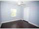Bright bedroom boasts hardwood floors, a window, and a closet for storage at 8909 N Dexter Ave, Tampa, FL 33604