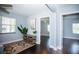 Cozy living room featuring hardwood floors, neutral paint, and natural light from a large window at 8909 N Dexter Ave, Tampa, FL 33604