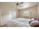 Bedroom featuring wood-look floors, a ceiling fan, and a comfortable queen-sized bed at 919 Valmar St, Brandon, FL 33511
