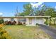 Charming single-story home featuring a well-manicured front yard and an attached garage at 919 Valmar St, Brandon, FL 33511