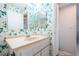 Bathroom featuring a mirrored vanity, and closet at 9214 Mission Oaks Blvd, Seminole, FL 33776