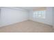 Cozy bedroom with neutral carpet and natural light from window at 9214 Mission Oaks Blvd, Seminole, FL 33776