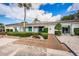 Charming home exterior with solar panels, manicured landscaping, and inviting front entrance at 9214 Mission Oaks Blvd, Seminole, FL 33776