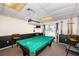 Fun game room featuring a pool table, bar stools, and view of the pool area at 9214 Mission Oaks Blvd, Seminole, FL 33776