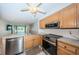 Well-equipped kitchen with stainless steel appliances and open layout at 9214 Mission Oaks Blvd, Seminole, FL 33776