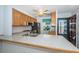 This kitchen features light wood cabinets, modern appliances, and a breakfast bar top with room for seating at 9214 Mission Oaks Blvd, Seminole, FL 33776