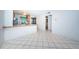 The combined kitchen and dining space boasts a ceiling fan, a breakfast bar, and tile floors at 9214 Mission Oaks Blvd, Seminole, FL 33776
