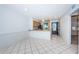 Open kitchen featuring a breakfast bar, neutral countertops, wood cabinets, and tiled floors at 9214 Mission Oaks Blvd, Seminole, FL 33776
