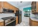 Efficient kitchen features stainless steel appliances and light oak cabinets at 9214 Mission Oaks Blvd, Seminole, FL 33776