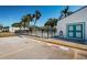 Community pool area features a gated pool, palm trees, and a car wash only parking spot at 9214 Mission Oaks Blvd, Seminole, FL 33776