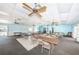 Large recreation room with tables, chairs, ceiling fans, and ample space for activities at 9214 Mission Oaks Blvd, Seminole, FL 33776