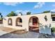 Arched gate with ironwork detail leading to front entry; exterior lighting at 1006 Mandalay Dr, Brandon, FL 33511